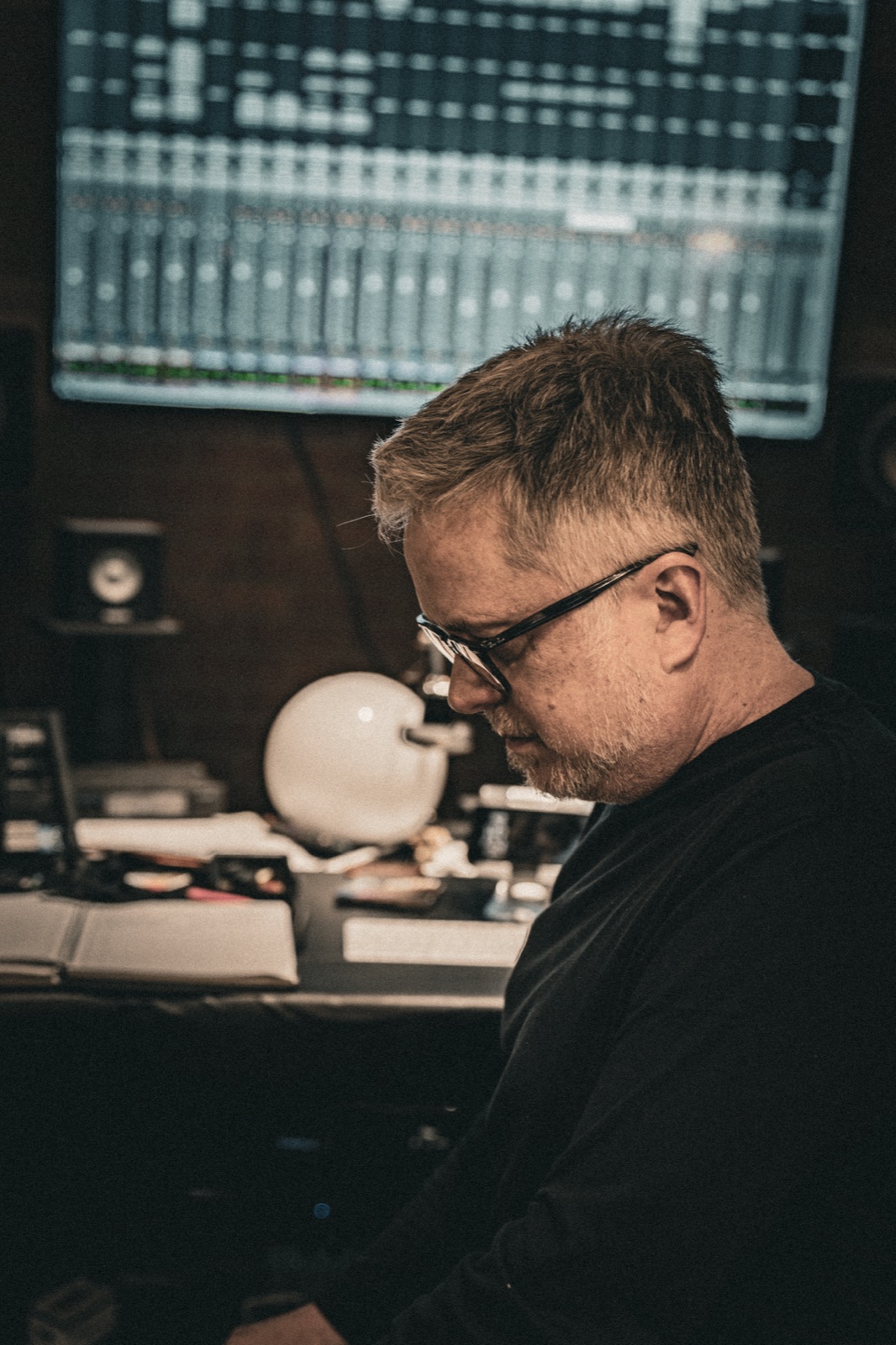 Tom Michael in profile at the mixing console.